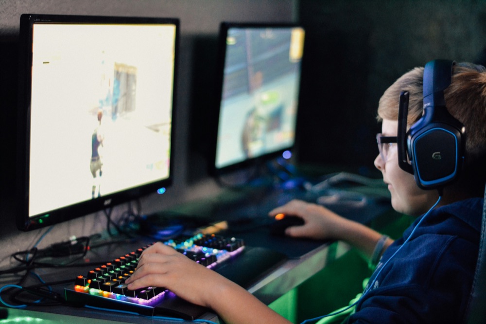 A kid playing on a gaming PC as part of an esports program