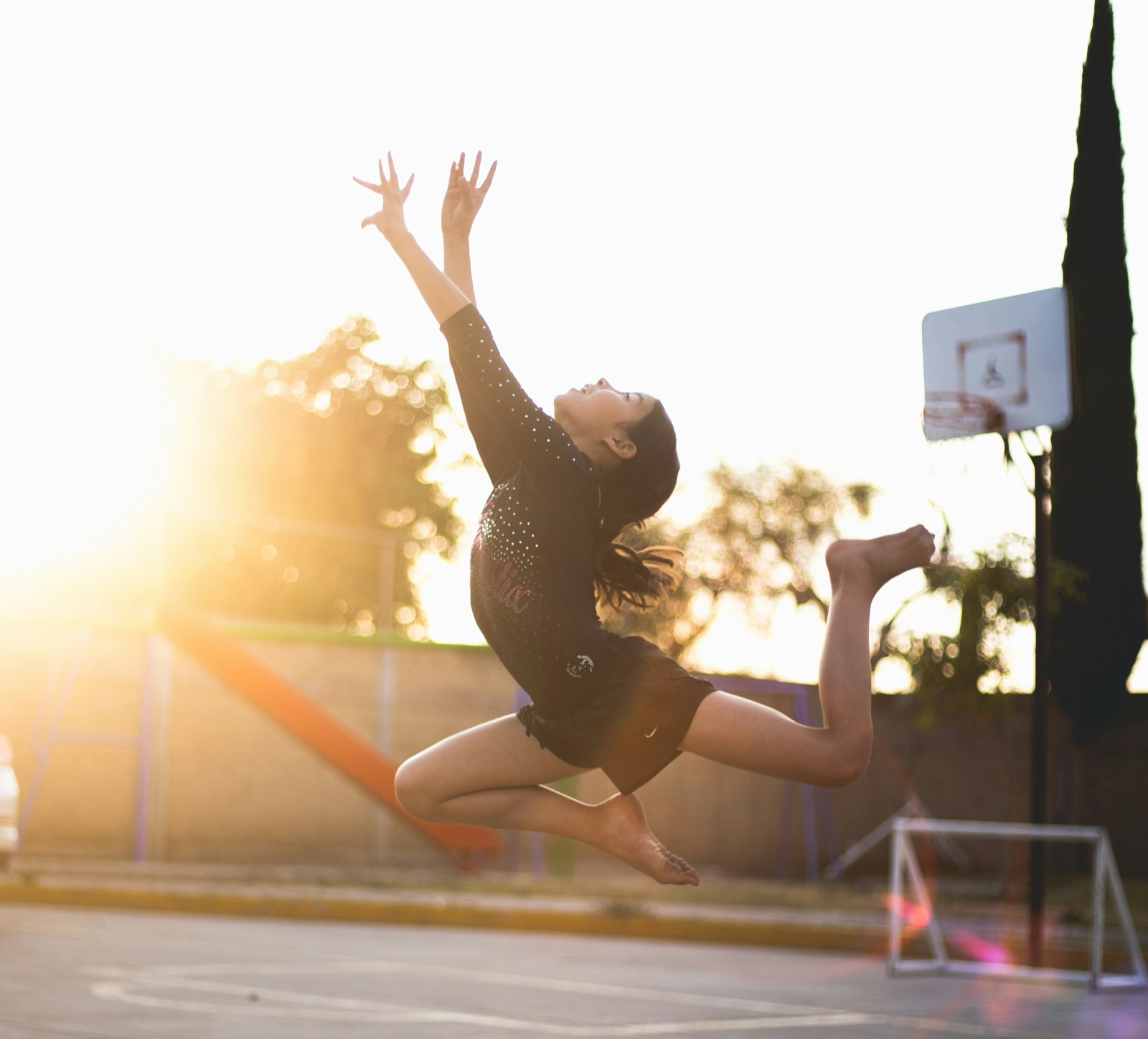 A young athlete leaping upward, reaching for the sky
