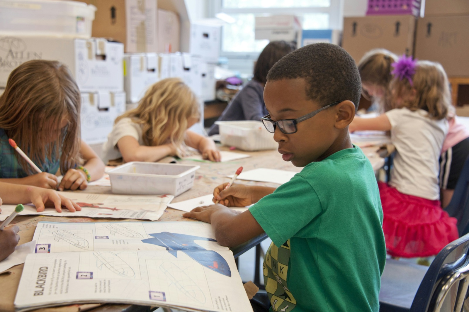 Kids working on a hands-on project together in class